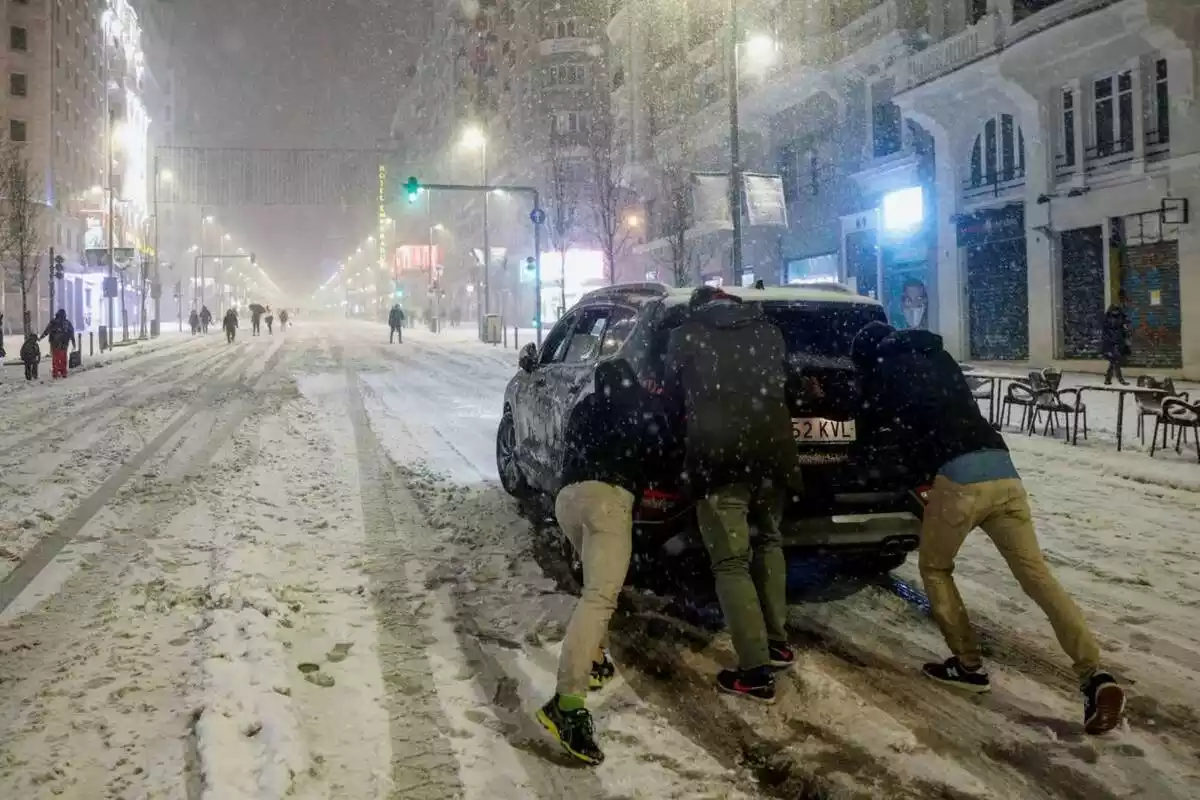 Imagen de un coche atrapado por el temporal de nieve en Madrid